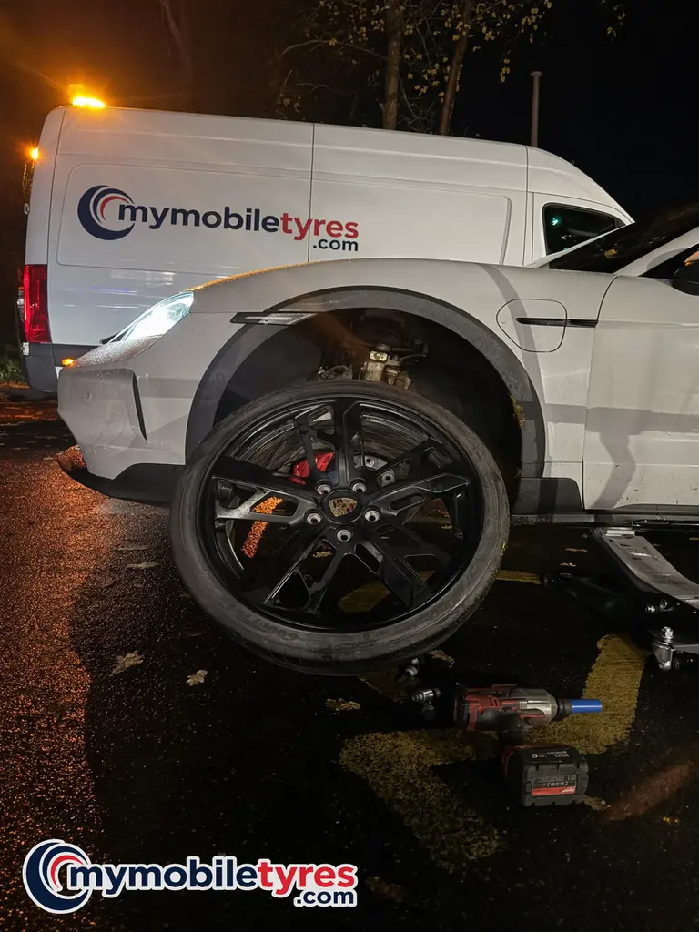 Mobile tyre fitter working on a car tyre in Oxford