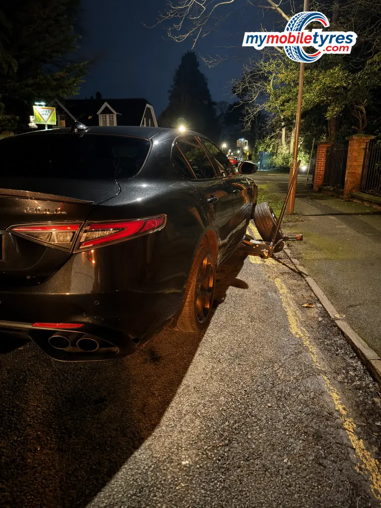 Mobile tyre fitter working on a car tyre in Oxford